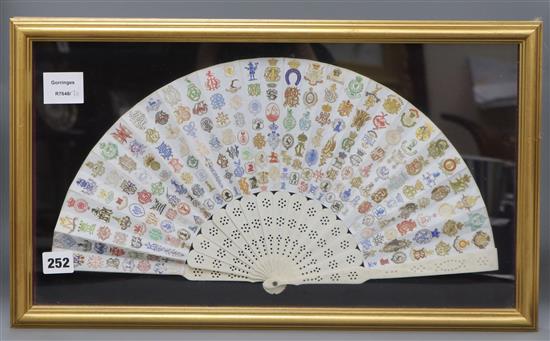 A framed ivory fan decorated with letter crests fan width 45cm height 23cm